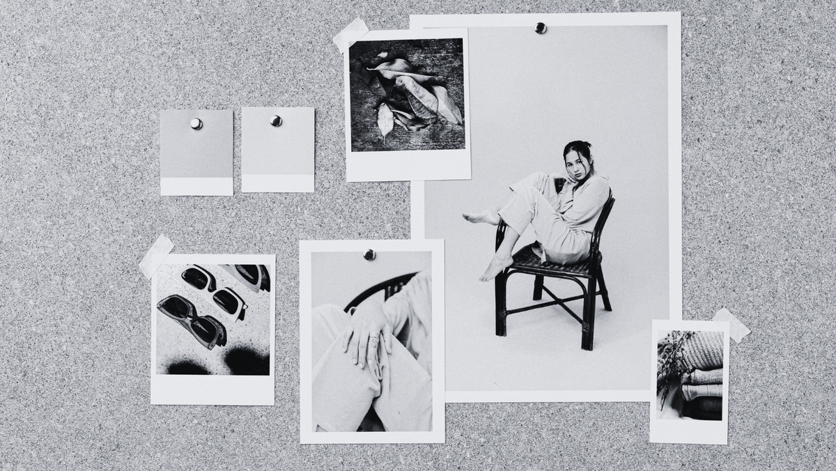 Branding mood board of black and white fashion photos pinned to a felt board